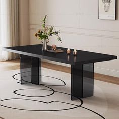 a black table sitting on top of a white floor next to a vase filled with flowers