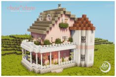 a large pink house sitting on top of a lush green field