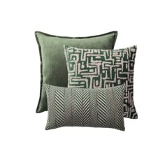 three green pillows with black and white designs on the front, one is made out of velvet