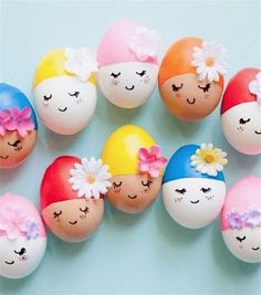 an assortment of painted eggs with faces and flowers on them