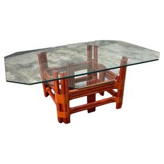 a wooden table with glass top and two chairs on the bottom one is made out of wood