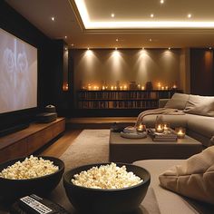 Luxurious private home theater with plush sofa, candlelit ambiance, and popcorn bowls. Ideal for a cozy movie night at home. Luxurious Home Theater, Cinema Room Design, Cozy Candlelight, Theater Room Design, Cozy Sectional, Home Cinema Room, At Home Movie Theater, Plush Sofa, Home Theater Rooms