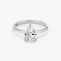 a pear shaped diamond ring on a white background