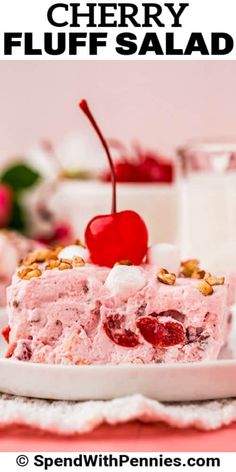 a piece of cherry fluff salad on a plate with a glass of milk in the background