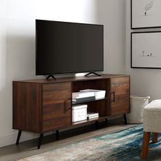 a flat screen tv sitting on top of a wooden cabinet