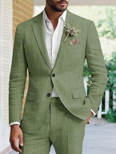 a man wearing a green suit and white shirt