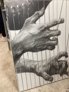 a black and white drawing of two hands reaching for each other in front of a cage