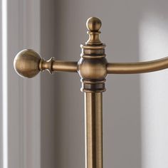 an antique brass finish metal bed frame with ball finial and round knobs on the headboard