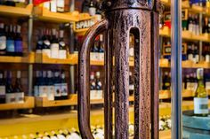 a large metal object in front of shelves with wine bottles