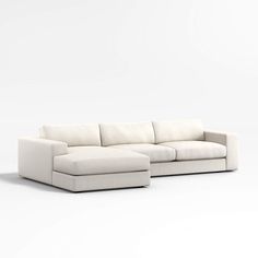 a white couch sitting on top of a white floor