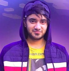 a young man wearing a purple jacket and yellow t - shirt is looking at the camera