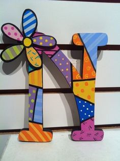 a colorful wooden letter with a flower on it