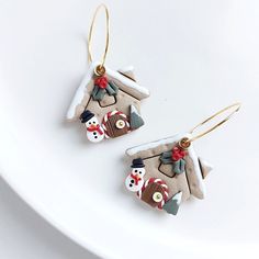 the earrings are made out of clay and decorated with snowmen, hats, and candy canes