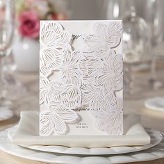 a table set with place settings, plates and napkins for an elegant wedding reception