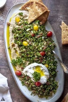 a white plate topped with food next to crackers