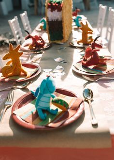 the table is set with plates, forks and napkins for children's birthday party