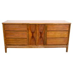 a large wooden dresser with two drawers on one side and three doors on the other