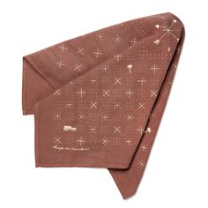 a brown bandana with white crosses on it