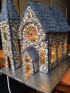 a small model of a church made out of rocks and stone veneers on a table