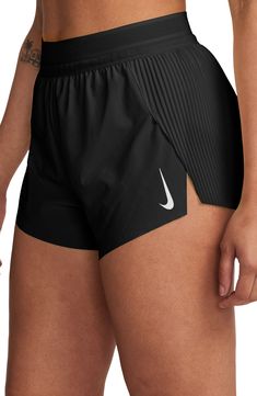 These mid-rise running shorts offer moisture-wicking comfort and side slits to keep you moving with comfort and confidence. 3" inseam; 23" leg opening; 12 1/2" front rise; 15" back rise (size Medium) Elastic waist with internal drawcord Three internal drop-in pockets Dri-FIT moisture-wicking technology Stretch lining 86% polyester, 14% spandex Machine wash, tumble dry Imported High Waisted Running Shorts, Track And Field Essentials, Aerie Shorts Outfit, Runners Outfit Women, Track Outfits Runners, Cute Athletic Outfits For Summer, Baggy Gym Fits, Summer Activewear Outfits, Nike Aeroswift Shorts