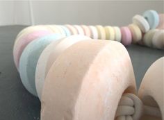 there are many different colored soaps on the table together, including one with a knot at the end