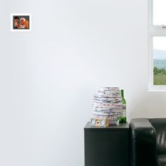 a black and white photo with blue eyes on the wall next to a leather couch