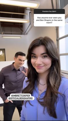 a woman standing next to a man in an office