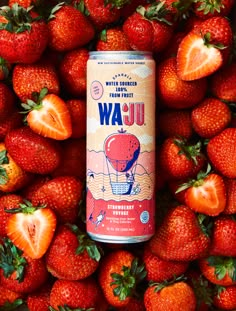 a can of strawberry water surrounded by strawberries