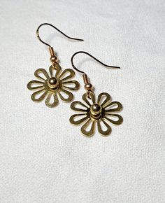 Dangle Earrings Gold Daisies are just over 1.25 inches long. These cute flowers were part of another piece of jewelry I disassembled. These simple yet elegant earrings are fun for everyday, especially in the spring or summer. Brass Drop Earrings With Flower Charm, Metal Flower Charm Earrings For Spring, Metal Flower Charm Drop Earrings, Metal Drop Earrings With Flower Charm, Dainty Dangle Earrings For Spring, Spring Dainty Dangle Earrings, Dainty Spring Dangle Earrings, Brass Flower Charm Earrings, Metal Flower-shaped Earrings For Spring