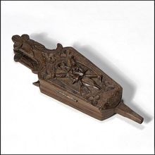 an old wooden carved object on a white background