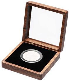 an empty wooden box with a silver coin in it's lid and black velvet lining