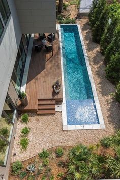 an aerial view of a swimming pool and deck in a home's back yard