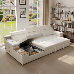 a living room with a white couch and open storage compartment