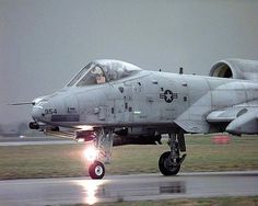 a fighter jet sitting on top of an airport runway