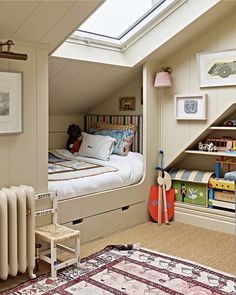 an attic bedroom with a bed, bookshelf and toy cars on the floor