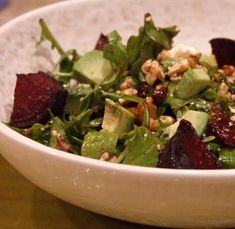 a salad in a white bowl on a table