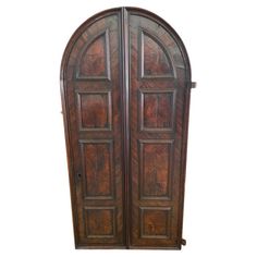 an antique wooden double door with arched top and side panels on both sides, isolated against a white background