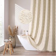 a bathroom with a bathtub and shower curtain next to a wooden stool in front of the tub