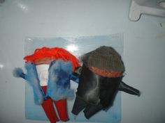 two hats and gloves sitting on top of each other