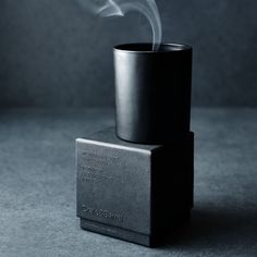 Utterly modern in monochromatic black. Our three-wick candle infuses the air with the invigorating scents of cypress, eucalyptus and thyme grounded by the richness of rose, myrrh and sandalwood. Packaged in a black gift box, the matte black glass vessel filled with black wax has a bold look that adds a touch of drama to your coffee table, dresser or mantel. Part of our exclusive Monochrome scent collection, the No. 02 Onyx candle is a Crate & Barrel exclusive.     Warm/earthy scent  Soy-vegetabl Luxury Candles Packaging, Scent Collection, Candle Wick Trimmer, Three Wick Candle, Earthy Scent, Candle Aesthetic, Crate Barrel, Candle Packaging, Old Fashioned Glass