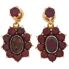 Mid-Century 1950's German garnet dangle cluster earrings. Set in 14k yellow gold with two oval center stones 1.10 cts total and 20 accent garnets. 2 oval reddish-brown garnets 1.10cts 2 round garnets .50 cts 18 round garnets 1.44cts 14k yellow gold 6.4 grams Hallmark: Germany Top to bottom: 2.61mm or .87 Inches Width: 13.21mm or .52 Inches Depth or thickness: 4.05mm Goddess Jewelry, Athena Goddess, Garnet Earrings, Reddish Brown, Cluster Earrings, Earrings Set, Garnet, Gold Earrings, Dangle Earrings