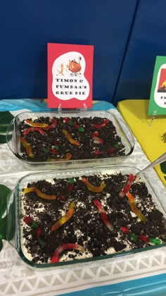 two trays filled with food sitting on top of a table next to each other