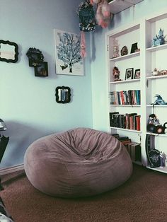 a bean bag chair sitting in front of a book shelf