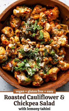 roasted cauliflower and chickpea salad in a wooden bowl with a spoon