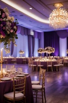 the tables are set up with purple and white linens for an elegant wedding reception