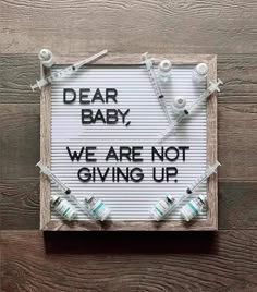 a sign that says dear baby, we are not giving up