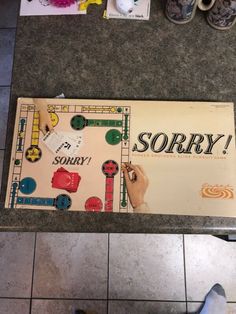 a board game sitting on top of a tile floor next to a pair of shoes