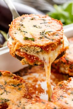 a close up of food being lifted from a casserole dish by a fork