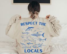 "Elevate your style and make a statement with our \"Protect the Locals\" Shark Sweatshirt, featuring an eye-catching display of  illustrated sharks on the back. Dive into the world of marine conservation fashion while showcasing your love for these magnificent creatures. 🦈 Key Features: ✨ Unique Design: Our sweatshirt showcases 6 meticulously illustrated shark species, celebrating the beauty and diversity of marine life. 🌊 Eco-Friendly Apparel: Crafted with sustainability in mind, this sweatshirt promotes environmental awareness and protection. 🧡 Support Marine Conservation: Wear your passion for sharks proudly and contribute to their preservation with each purchase. 🎁 Thoughtful Gift: Surprise a friend or family member who shares your appreciation for marine wildlife. **HOW TO ORDER** Respect The Locals, Shark Illustration, Shark Sweatshirt, Vsco Hoodie, Diverse Beauty, Beach Hoodie, Bday Gifts, Shark Hoodie, Teenager Gifts