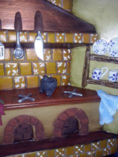 a wooden stove top oven sitting next to a counter with utensils on it